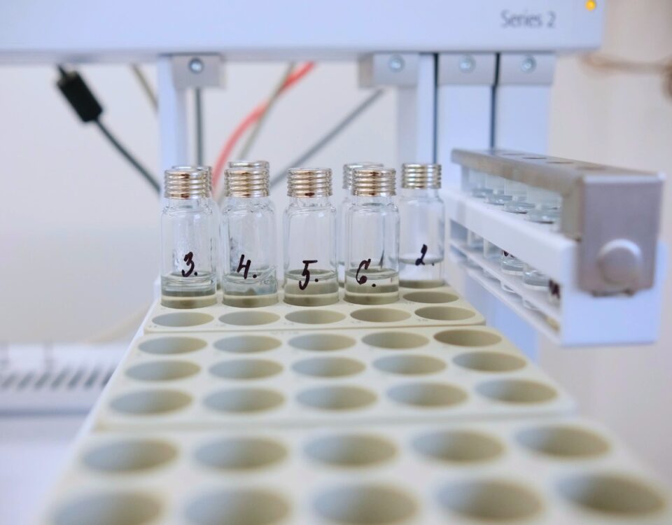 Laboratory samples of cleaning products in labeled test tubes, prepared for testing the cloud point and stability of formulations containing hydrotropes.